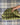 Olive windowpane + carmel | black
Carmel Patent Leather Trim.  Black and white pinstripe interior.
Green checkered clutch on a white background